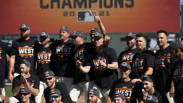 Oct 3, 2021; San Francisco, California, USA; San Francisco Giants players and coaches pose for a group photo as they celebrate their 11-4 victory over the San Diego Padres at Oracle Park. The Giants clinched the National League West Division with the win. Mandatory Credit: D. Ross Cameron-USA TODAY Sports