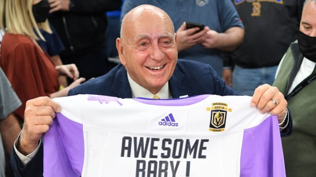 Nov 23, 2021; Las Vegas, Nevada, USA; Basketball commentator Dick Vitale poses with a Vegas Golden Knights Hockey Fights Cancer jersey given to him before the start of a game between the Gonzaga Bulldogs and the UCLA Bruins at T-Mobile Arena. Mandatory Credit: Stephen R. Sylvanie-USA TODAY Sports