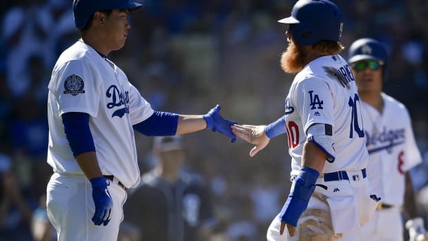 Sep 23, 2018; Los Angeles, CA, USA; Los Angeles Dodgers starting pitcher Hyun-Jin Ryu (left) celebrates with third baseman Justin Turner (10) after scoring off a single by first baseman Max Muncy (not pictured) during the fifth inning against the San Diego Padres at Dodger Stadium. Mandatory Credit: Kelvin Kuo-USA TODAY Sports