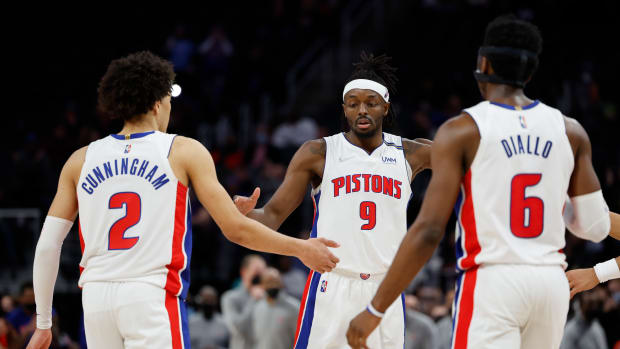 Dec 8, 2021; Detroit, Michigan, USA; Detroit Pistons forward Jerami Grant (9) receives congratulations from guard Cade Cunningham (2) and guard Hamidou Diallo (6) after he makes free throws in the second half against the Washington Wizards at Little Caesars Arena. Mandatory Credit: Rick Osentoski-USA TODAY Sports