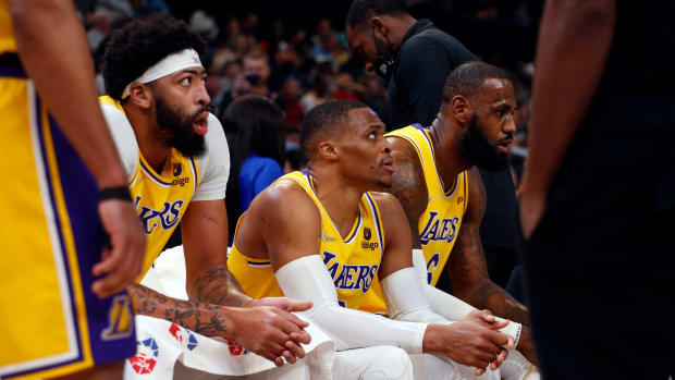 Dec 9, 2021; Memphis, Tennessee, USA; Los Angeles Lakers forward Anthony Davis (left), guard Russell Westbrook (center) and forward LeBron James (right) sit on the bench during a timeout in the first half against the Memphis Grizzles at FedExForum. Mandatory Credit: Petre Thomas-USA TODAY Sports