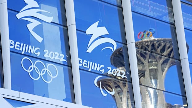 Feb 1, 2022; Beijing; China; A view of a Olympics Tower reflects in the window of the Main Press Center before the Beijing 2022 Winter Olympic Games. Mandatory Credit: Michael Madrid-USA TODAY Sports