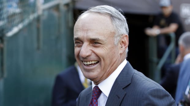Rob Manfred is the commissioner of MLB, smiling during recent playoff series.