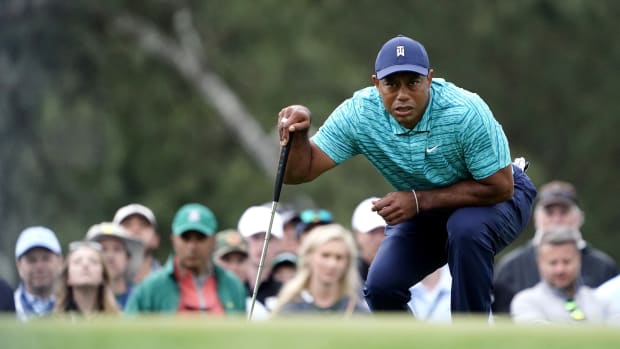 Apr 8, 2022; Augusta, Georgia, USA; Tiger Woods lines up his putt on no. 17 during the second round of The Masters golf tournament at Augusta National Golf Course. Mandatory Credit: Danielle Parhizkaran-Augusta Chronicle/USA TODAY Sports