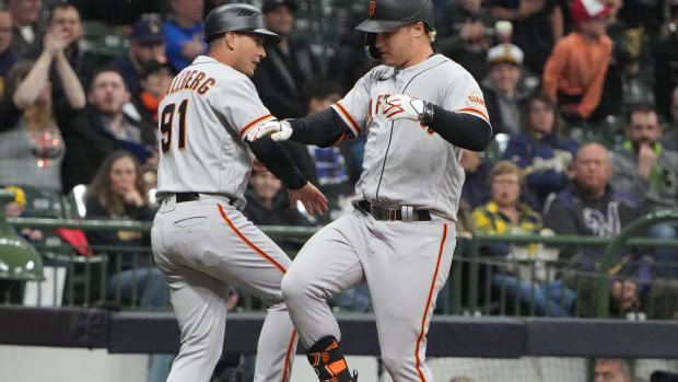 San Francisco Giants left fielder Joc Pederson (23) celebrates his two-run homer with third base coach Mark Hallberg (91) during the eighth inning of their game agains the Milwaukee Brewers Monday, April 25, 2022 at American Family Field in Milwaukee, Wis. Brewers26 14