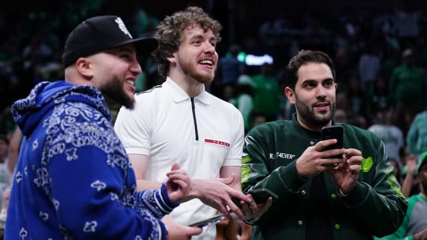 May 1, 2022; Boston, Massachusetts, USA; American rapper Jack Harlow (center) calls out to the referee for a picture during a break in the action against the Boston Celtics and Milwaukee Bucks in the second half during game one of the second round for the 2022 NBA playoffs at TD Garden. Mandatory Credit: David Butler II-USA TODAY Sports