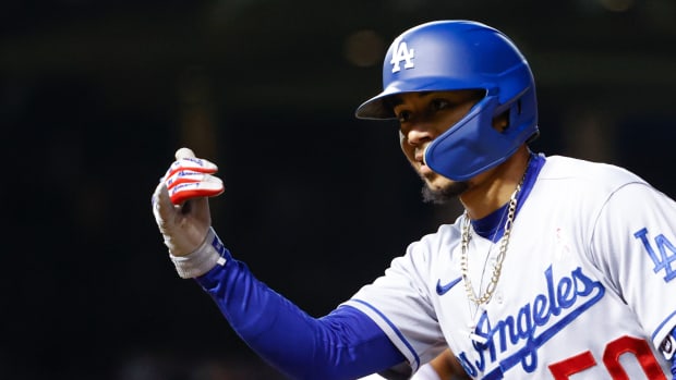 May 8, 2022; Chicago, Illinois, USA; Los Angeles Dodgers right fielder Mookie Betts (50) celebrates after hitting a single against the Chicago Cubs during the seventh inning at Wrigley Field. Mandatory Credit: Kamil Krzaczynski-USA TODAY Sports