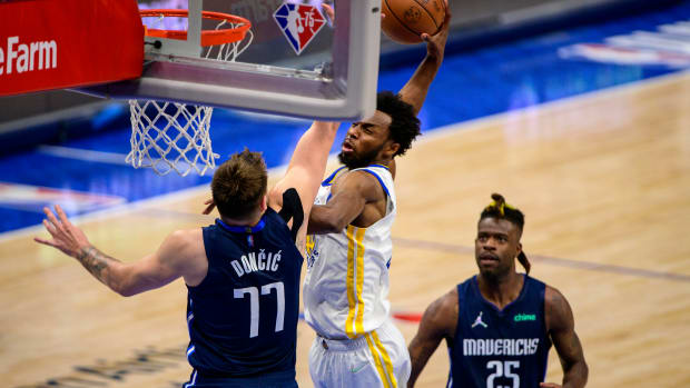 May 22, 2022; Dallas, Texas, USA; Golden State Warriors forward Andrew Wiggins (22) dunks the ball over Dallas Mavericks guard Luka Doncic (77) during the fourth quarter in game three of the 2022 western conference finals at American Airlines Center. Mandatory Credit: Jerome Miron-USA TODAY Sport