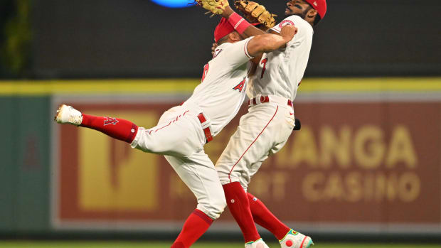 Jun 8, 2022; Anaheim, California, USA; Los Angeles Angels left fielder Jo Adell (7) hangs on to the ball as he collides with second baseman Jack Mayfield #9 for an out off a ball hit by Boston Red Sox shortstop Xander Bogaerts (2) in the eighth inning at Angel Stadium. Mandatory Credit: Jayne Kamin-Oncea-USA TODAY Sports