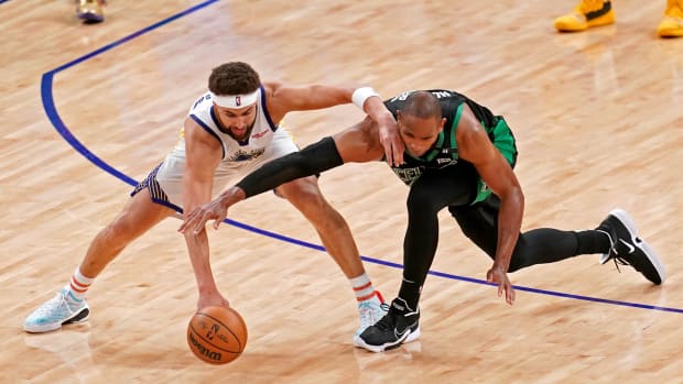 Jun 13, 2022; San Francisco, California, USA; Golden State Warriors guard Klay Thompson (11) and Boston Celtics center Al Horford (42) go for the ball during the fourth quarter in game five of the 2022 NBA Finals at Chase Center. Mandatory Credit: Cary Edmondson-USA TODAY Sports