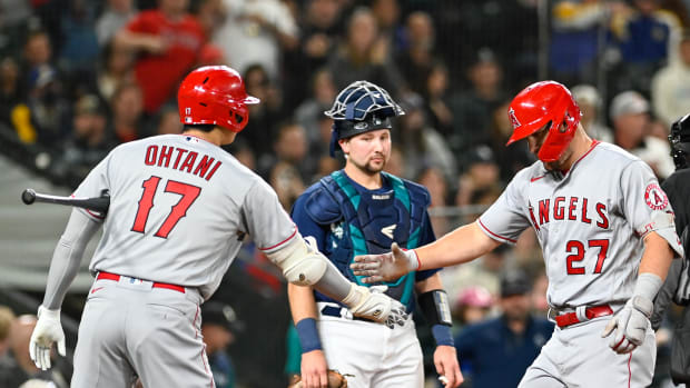 Jun 18, 2022; Seattle, Washington, USA; Los Angeles Angels center fielder Mike Trout (27) celebrates with designated hitter Shohei Ohtani (17) at home plate after Trout hit a home run against the Seattle Mariners during the third inning at T-Mobile Park. Mandatory Credit: Steven Bisig-USA TODAY Sports