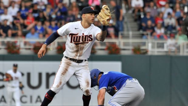 Aug 6, 2022; Minneapolis, Minnesota, USA; Minnesota Twins shortstop Carlos Correa (4) reacts after Toronto Blue Jays center fielder Whit Merrifield (1) steals second base during the fourth inning at Target Field. Mandatory Credit: Jeffrey Becker-USA TODAY Sports