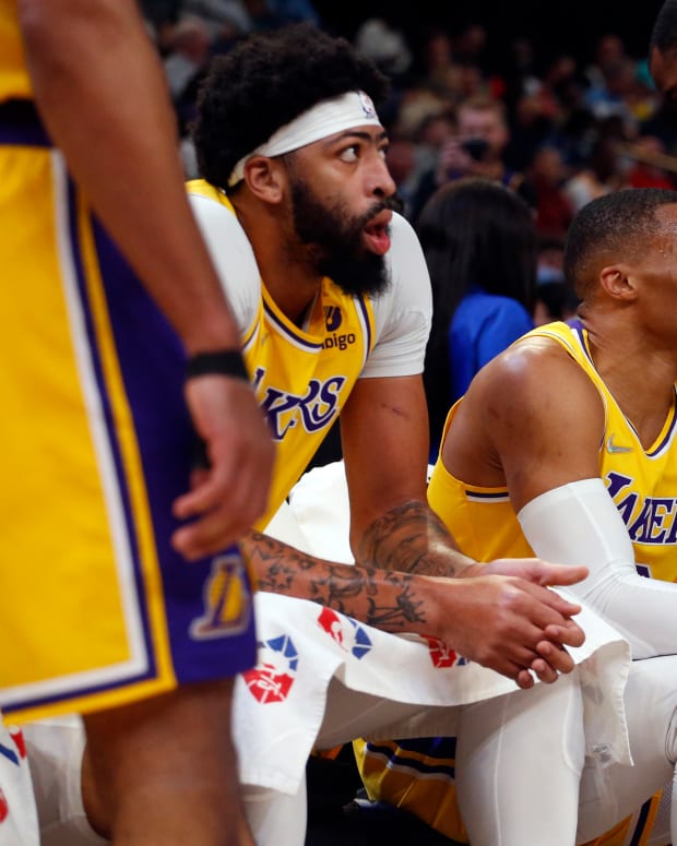 Dec 9, 2021; Memphis, Tennessee, USA; Los Angeles Lakers forward Anthony Davis (left), guard Russell Westbrook (center) and forward LeBron James (right) sit on the bench during a timeout in the first half against the Memphis Grizzles at FedExForum. Mandatory Credit: Petre Thomas-USA TODAY Sports
