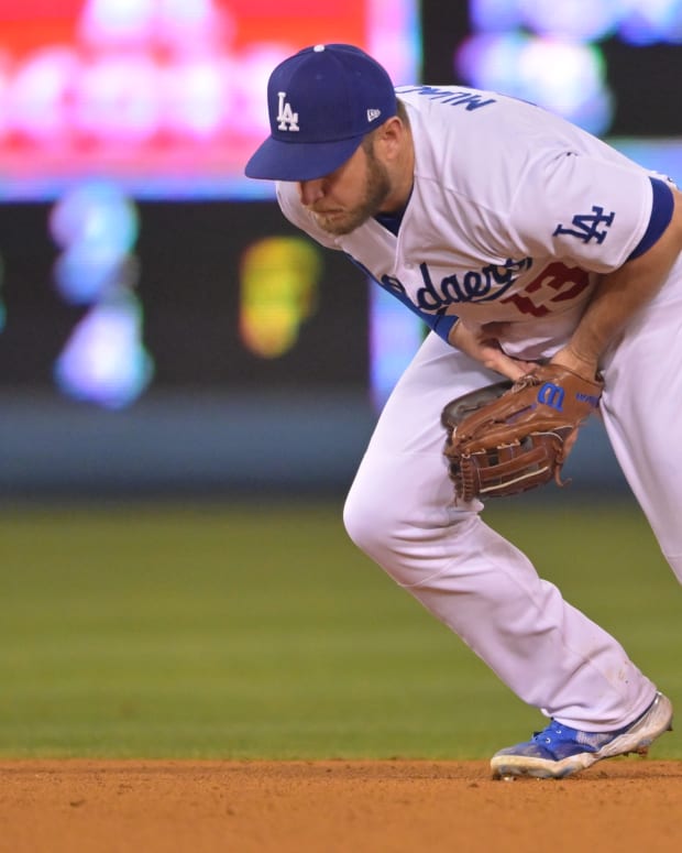 May 13, 2022; Los Angeles, California, USA; Los Angeles Dodgers second baseman Max Muncy (13) is charged with an error on a ball hit by Philadelphia Phillies third baseman Bryson Stott (5) in the ninth inning at Dodger Stadium. Mandatory Credit: Jayne Kamin-Oncea-USA TODAY Sports