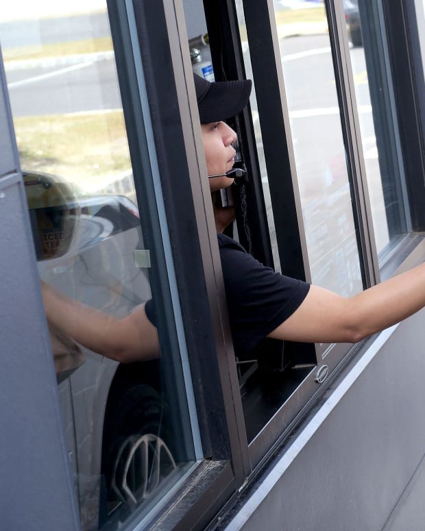 Rosa Alavez, Freehold Boro, hands an order to a drive-thru customer at the Monmouth Road Taco Bell restaurant in Jackson Friday, June 24, 2022. Drive Thru Lanes Growth